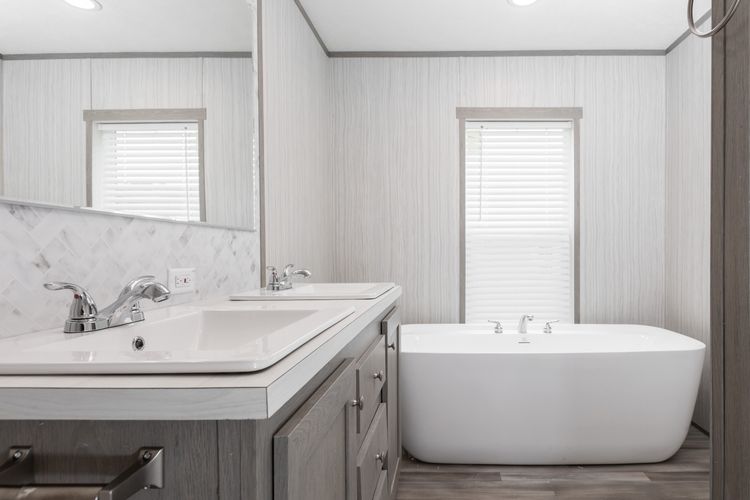 The THE POWERHOUSE Primary Bathroom. This Manufactured Mobile Home features 3 bedrooms and 2 baths.