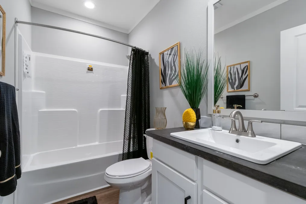 The THE CHANEL Guest Bathroom. This Manufactured Mobile Home features 4 bedrooms and 3 baths.