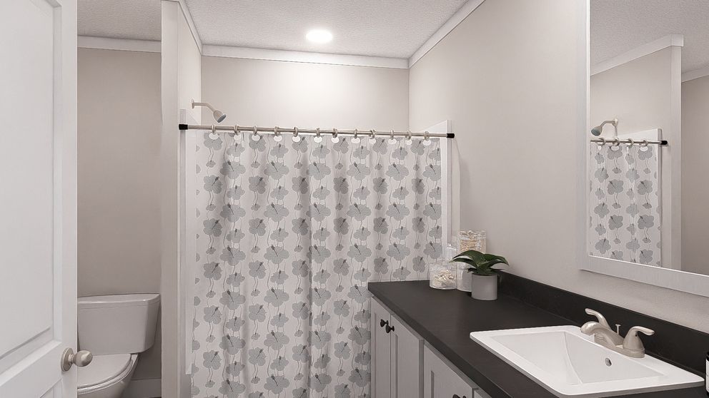 The LET IT BE Primary Bathroom. This Manufactured Mobile Home features 3 bedrooms and 2 baths.