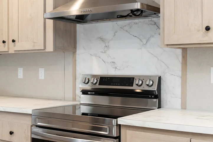 The THE ANNIVERSARY ISLANDER Kitchen. This Manufactured Mobile Home features 3 bedrooms and 2 baths.