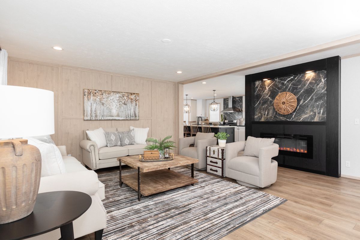 The 6032-5700 THE PULSE Living Room. This Manufactured Mobile Home features 3 bedrooms and 2 baths.