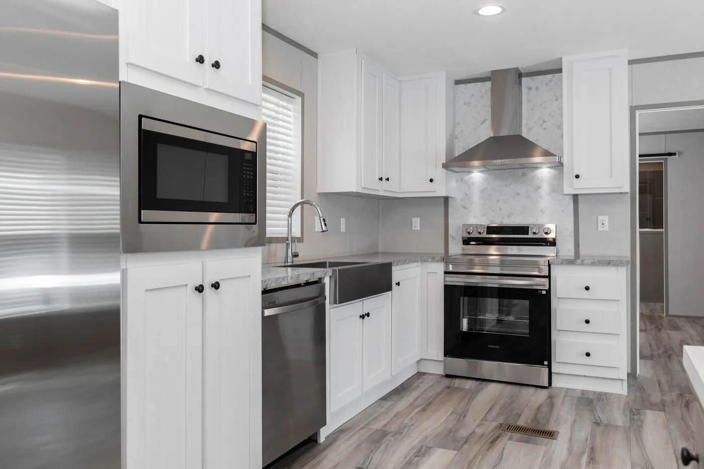 The THE ULTIMATE SHOWER Kitchen. This Manufactured Mobile Home features 3 bedrooms and 2 baths.