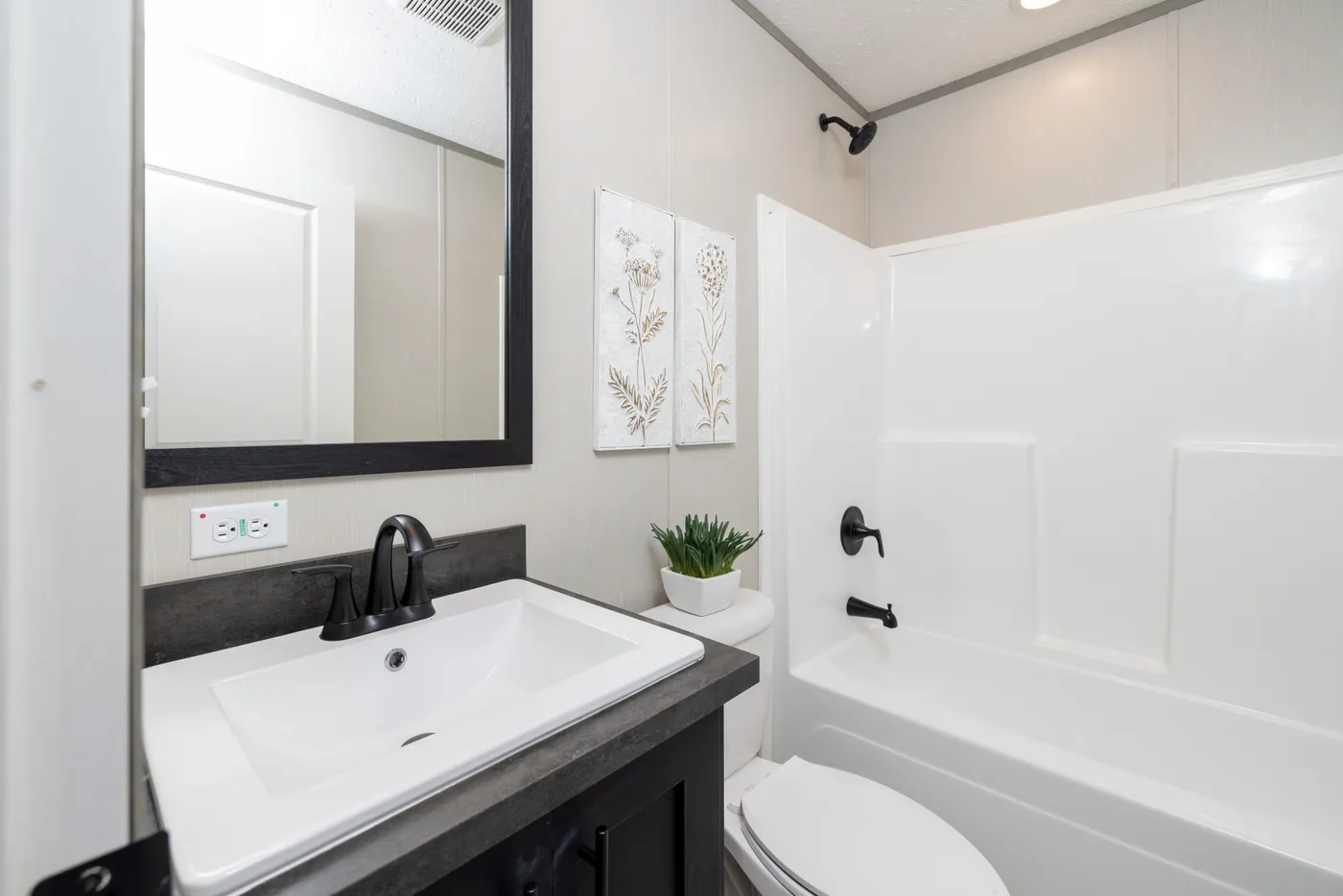 The SHOWER HOUSE Guest Bathroom. This Manufactured Mobile Home features 3 bedrooms and 2 baths.