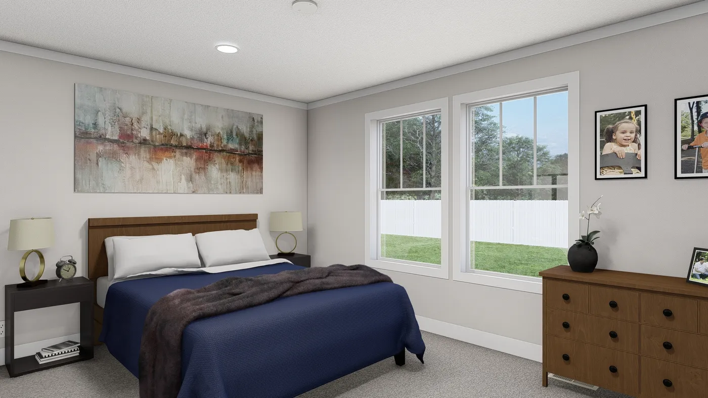 The THREE LITTLE BIRDS Primary Bedroom. This Manufactured Mobile Home features 3 bedrooms and 2 baths.