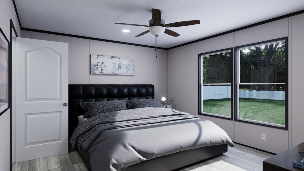 The THE MOUNTAINEER 56 Primary Bedroom. This Manufactured Mobile Home features 3 bedrooms and 2 baths.