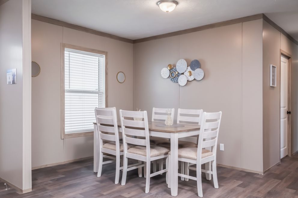 The FARMHOUSE BREEZE 72 Dining Room. This Manufactured Mobile Home features 4 bedrooms and 2 baths.