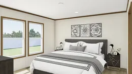 The THE REVEAL Primary Bedroom. This Manufactured Mobile Home features 3 bedrooms and 2 baths.