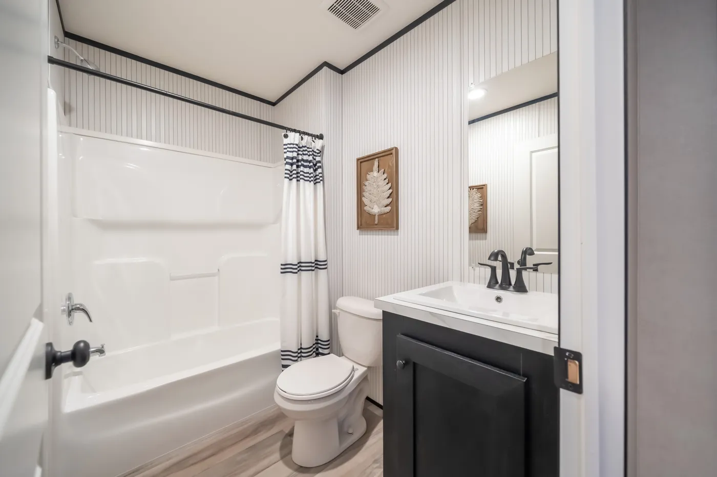 The THE SMOKEY Guest Bathroom. This Manufactured Mobile Home features 3 bedrooms and 2 baths.