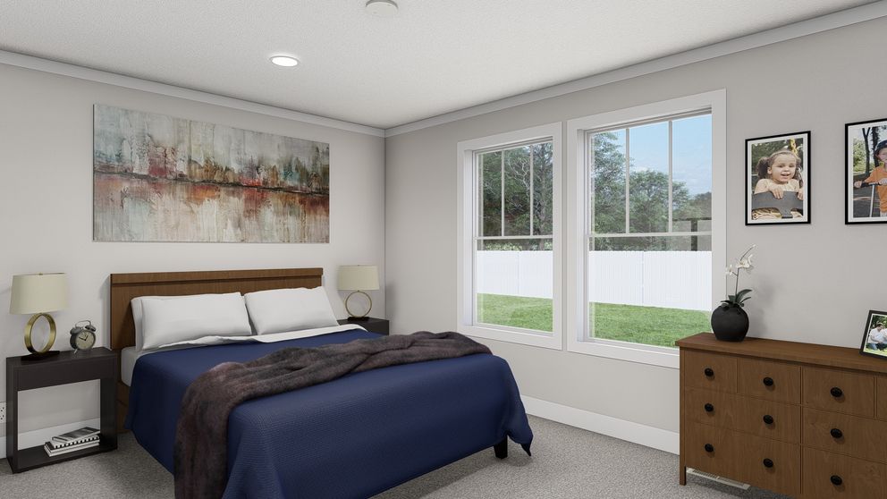 The THREE LITTLE BIRDS Primary Bedroom. This Manufactured Mobile Home features 3 bedrooms and 2 baths.