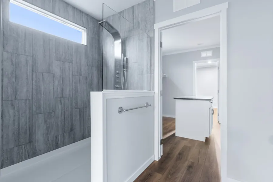 The THE OLYMPUS Primary Bathroom. This Manufactured Mobile Home features 4 bedrooms and 3 baths.