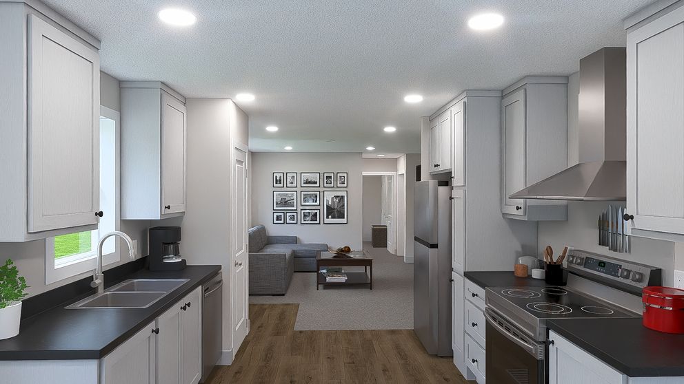 The HERE COMES THE SUN Kitchen. This Manufactured Mobile Home features 3 bedrooms and 2 baths.