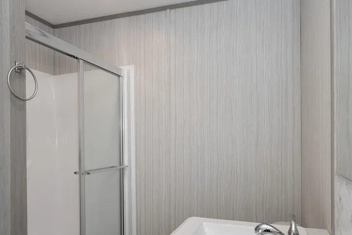 The THE POWERHOUSE Primary Bathroom. This Manufactured Mobile Home features 3 bedrooms and 2 baths.