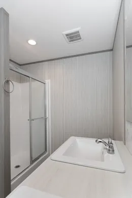 The THE POWERHOUSE Primary Bathroom. This Manufactured Mobile Home features 3 bedrooms and 2 baths.