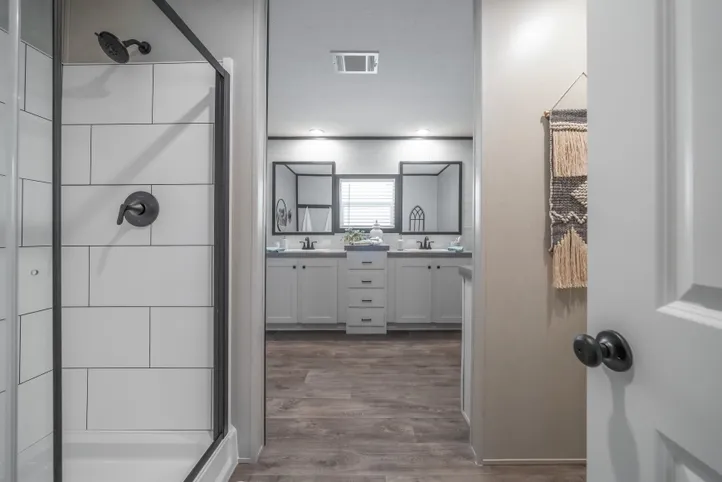 The BREEZE FARMHOUSE Primary Bathroom. This Manufactured Mobile Home features 3 bedrooms and 2 baths.