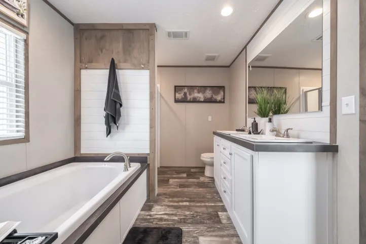 The RIVERHAVEN Primary Bathroom. This Manufactured Mobile Home features 3 bedrooms and 2 baths.