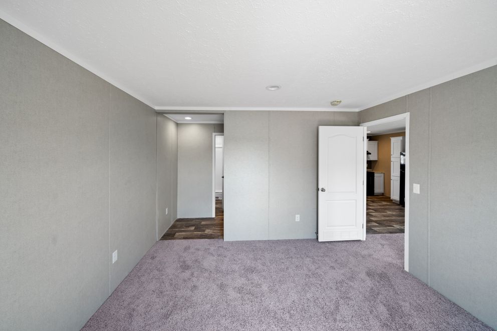 The ZIRCON Primary Bedroom. This Manufactured Mobile Home features 3 bedrooms and 2 baths.
