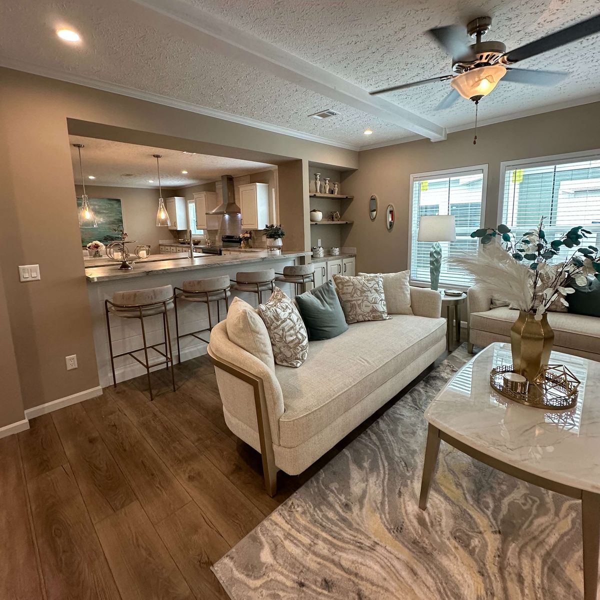 The THE HEXAGON Living Room. This Manufactured Mobile Home features 4 bedrooms and 3 baths.