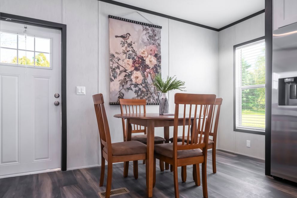 The LIL SOUTHERN CHARM Dining Room. This Manufactured Mobile Home features 3 bedrooms and 2 baths.