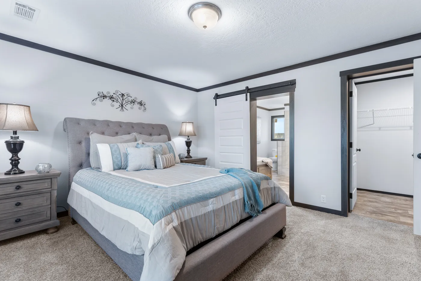 The BOUJEE XL Primary Bedroom. This Manufactured Mobile Home features 4 bedrooms and 3 baths.