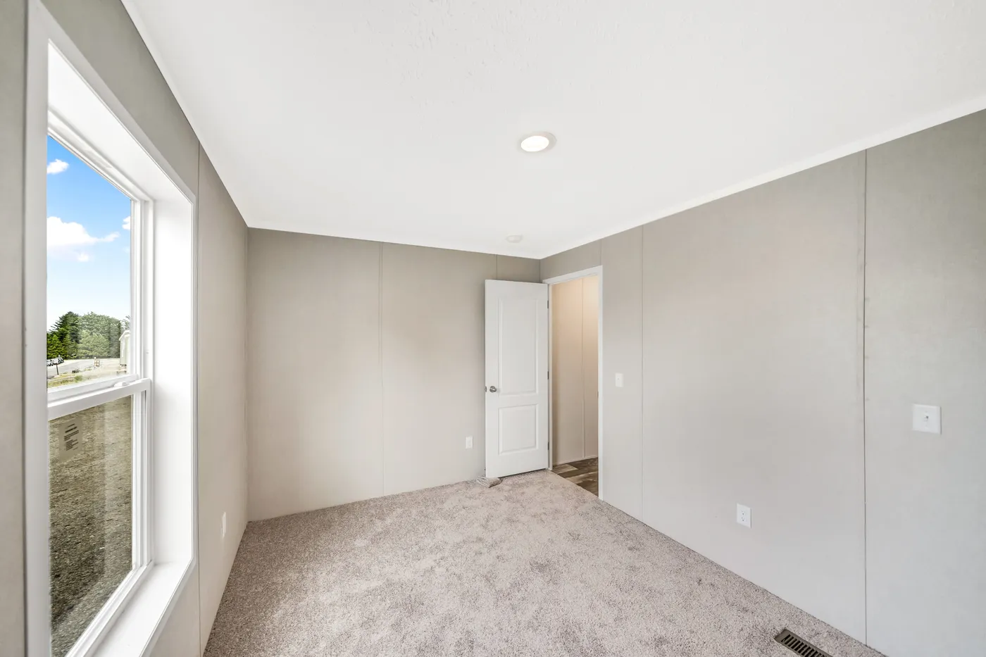 The RUBY Primary Bedroom. This Manufactured Mobile Home features 2 bedrooms and 2 baths.