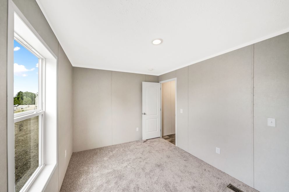The RUBY Primary Bedroom. This Manufactured Mobile Home features 2 bedrooms and 2 baths.
