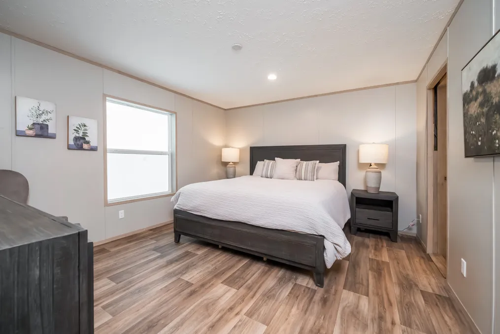 The BOONE Primary Bedroom. This Manufactured Mobile Home features 4 bedrooms and 2 baths.