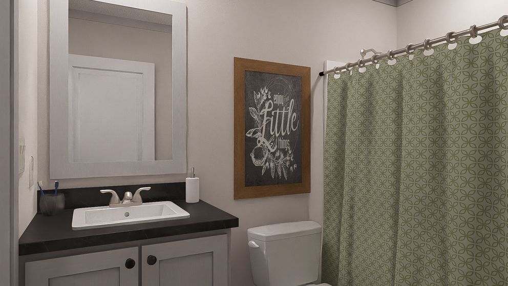 The STAYIN' ALIVE Guest Bathroom. This Manufactured Mobile Home features 3 bedrooms and 2 baths.