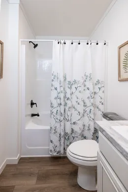 The THE ANNA FAE Guest Bathroom. This Manufactured Mobile Home features 3 bedrooms and 2 baths.