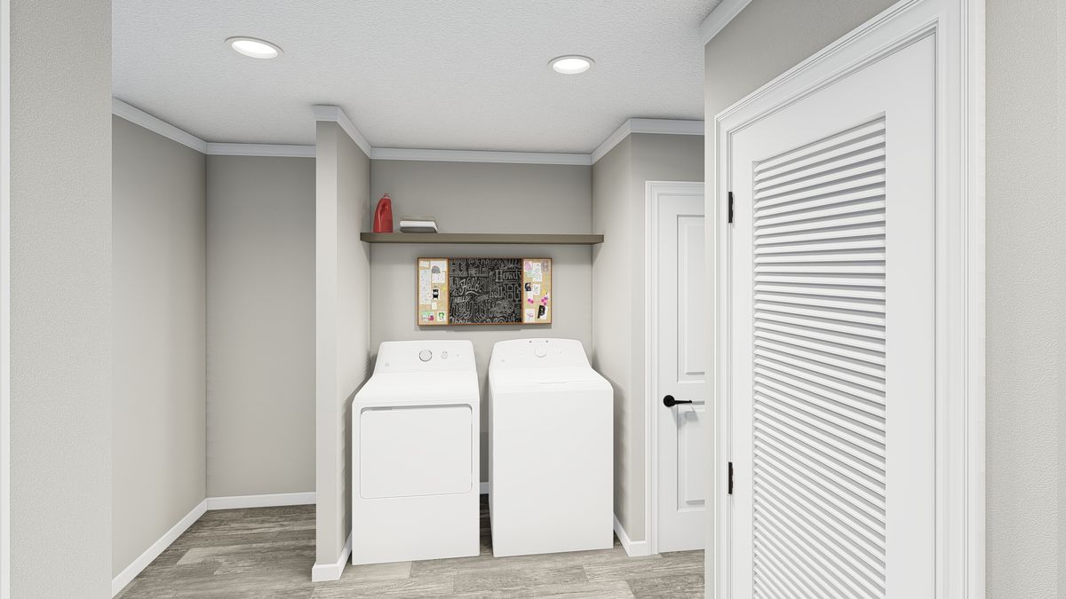 The THE LIL' EASY Utility Room. This Manufactured Mobile Home features 3 bedrooms and 2 baths.