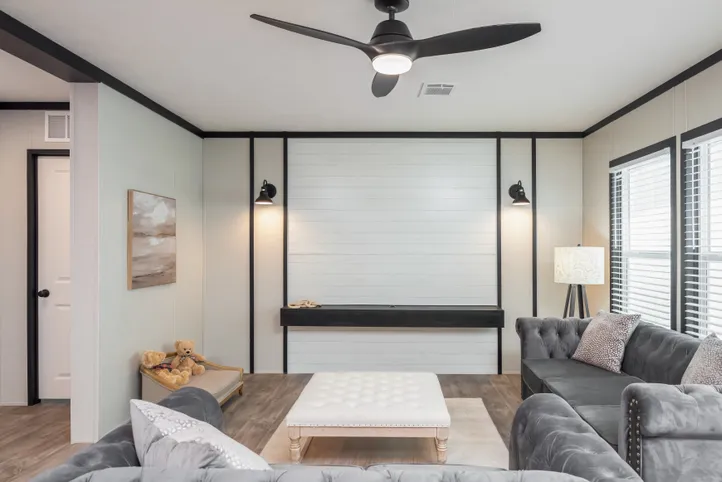 The BREEZE FARMHOUSE Living Room. This Manufactured Mobile Home features 3 bedrooms and 2 baths.