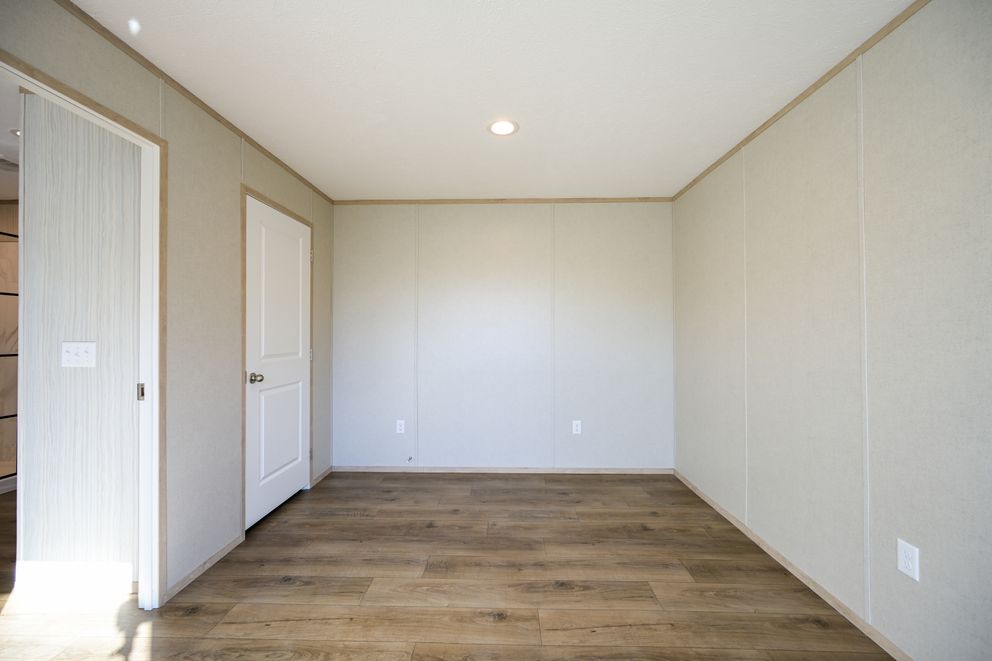 The TIGER'S EYE 7416-456 Primary Bedroom. This Manufactured Mobile Home features 3 bedrooms and 2 baths.