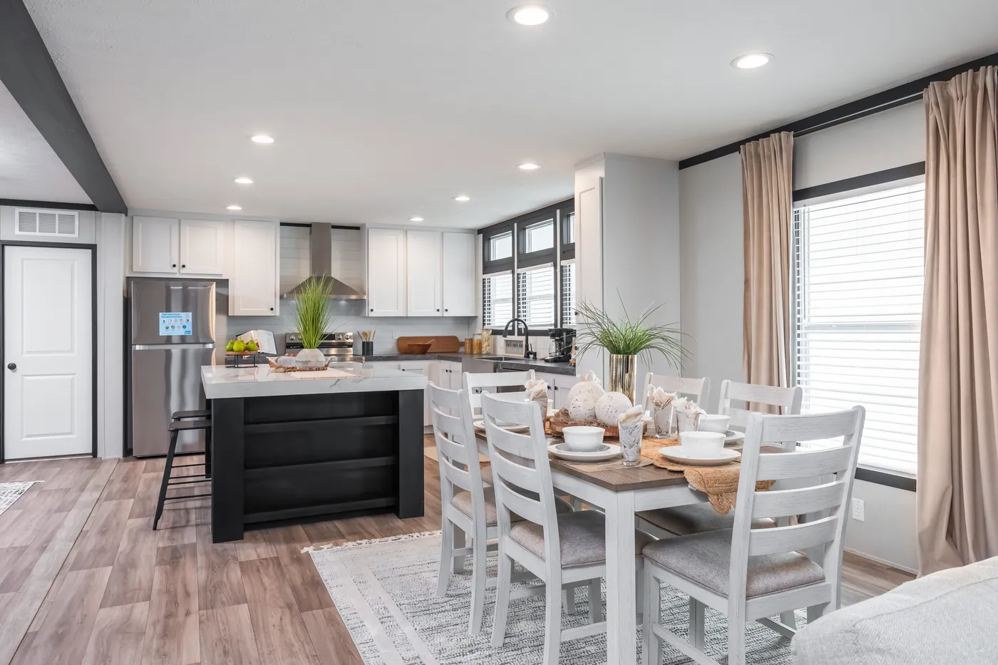 The ABSOLUTE VALUE Dining Area. This Manufactured Mobile Home features 4 bedrooms and 2 baths.