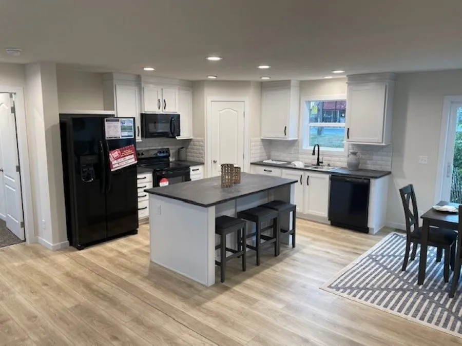 The MICHIGAN AVE/6028-MS026-1 SECT Kitchen. This Manufactured Mobile Home features 3 bedrooms and 2 baths.