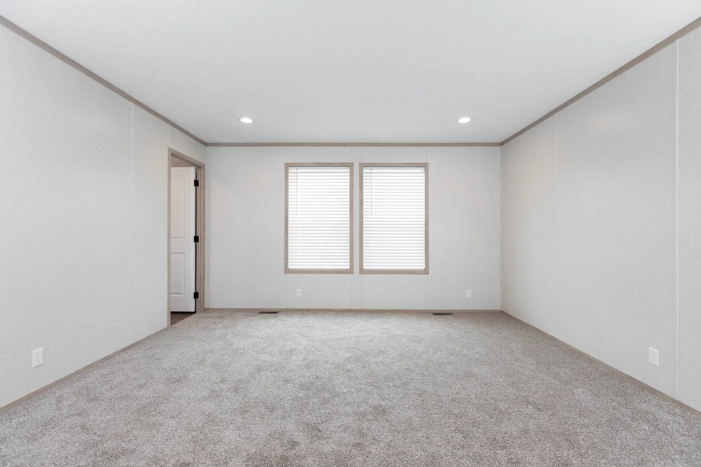 The 6032-5700 THE PULSE Primary Bedroom. This Manufactured Mobile Home features 3 bedrooms and 2 baths.