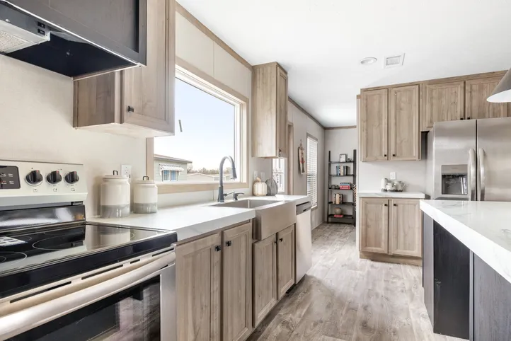 The STERLING XL ANNIVERSARY Kitchen. This Manufactured Mobile Home features 3 bedrooms and 2 baths.