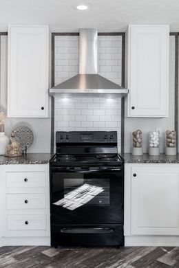 The THE SHOWER HOUSE 2.0 Kitchen. This Manufactured Mobile Home features 3 bedrooms and 2 baths.
