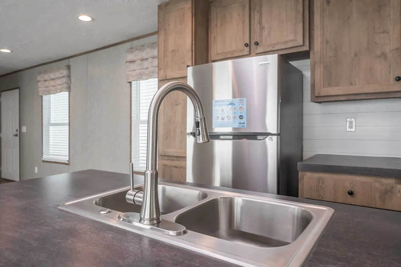 The LAKESIDE COTTAGE Kitchen. This Manufactured Mobile Home features 1 bedroom and 1 bath.