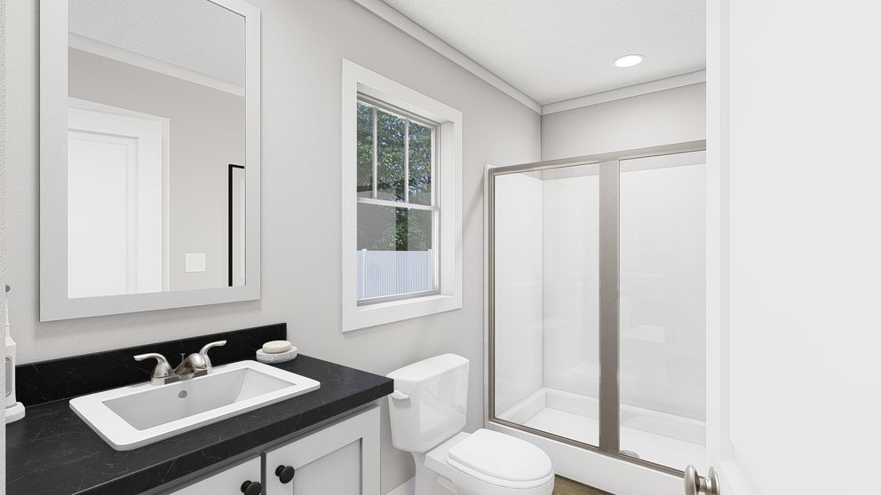 The RHYTHM NATION Primary Bathroom. This Manufactured Mobile Home features 3 bedrooms and 2 baths.