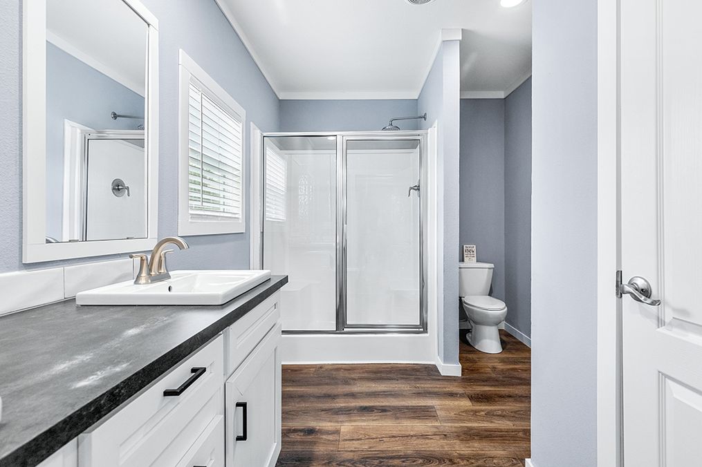 The THE COLONIAL Primary Bathroom. This Manufactured Mobile Home features 3 bedrooms and 2 baths.