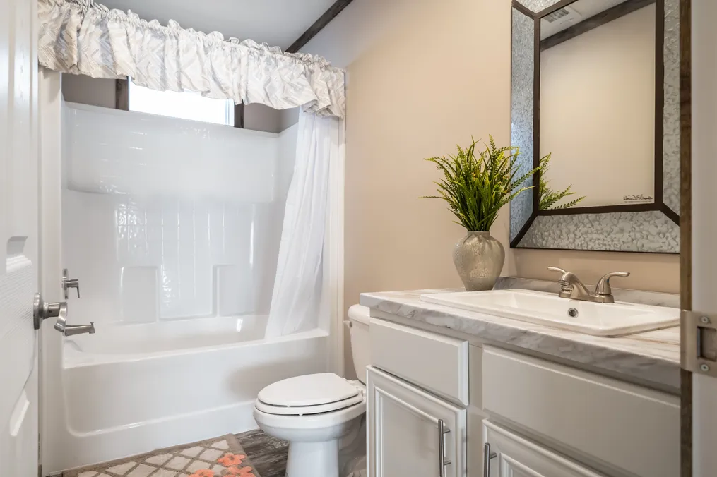The THE TYRA Guest Bathroom. This Manufactured Mobile Home features 4 bedrooms and 2 baths.