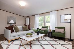 The PRIDE Living Room. This Manufactured Mobile Home features 4 bedrooms and 2 baths.