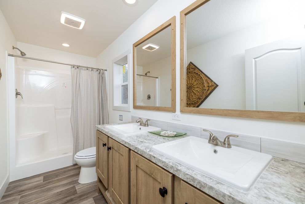 The JOHNNY B GOODE Primary Bathroom. This Manufactured Mobile Home features 3 bedrooms and 2 baths.