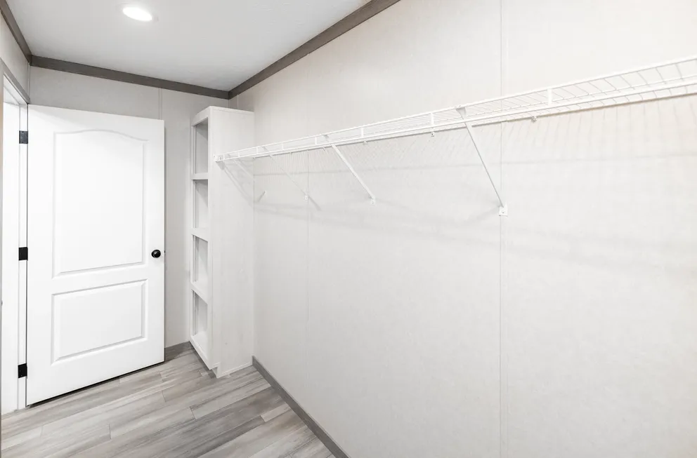 The 6428-E792 THE PULSE Primary Bedroom. This Manufactured Mobile Home features 3 bedrooms and 2.5 baths.