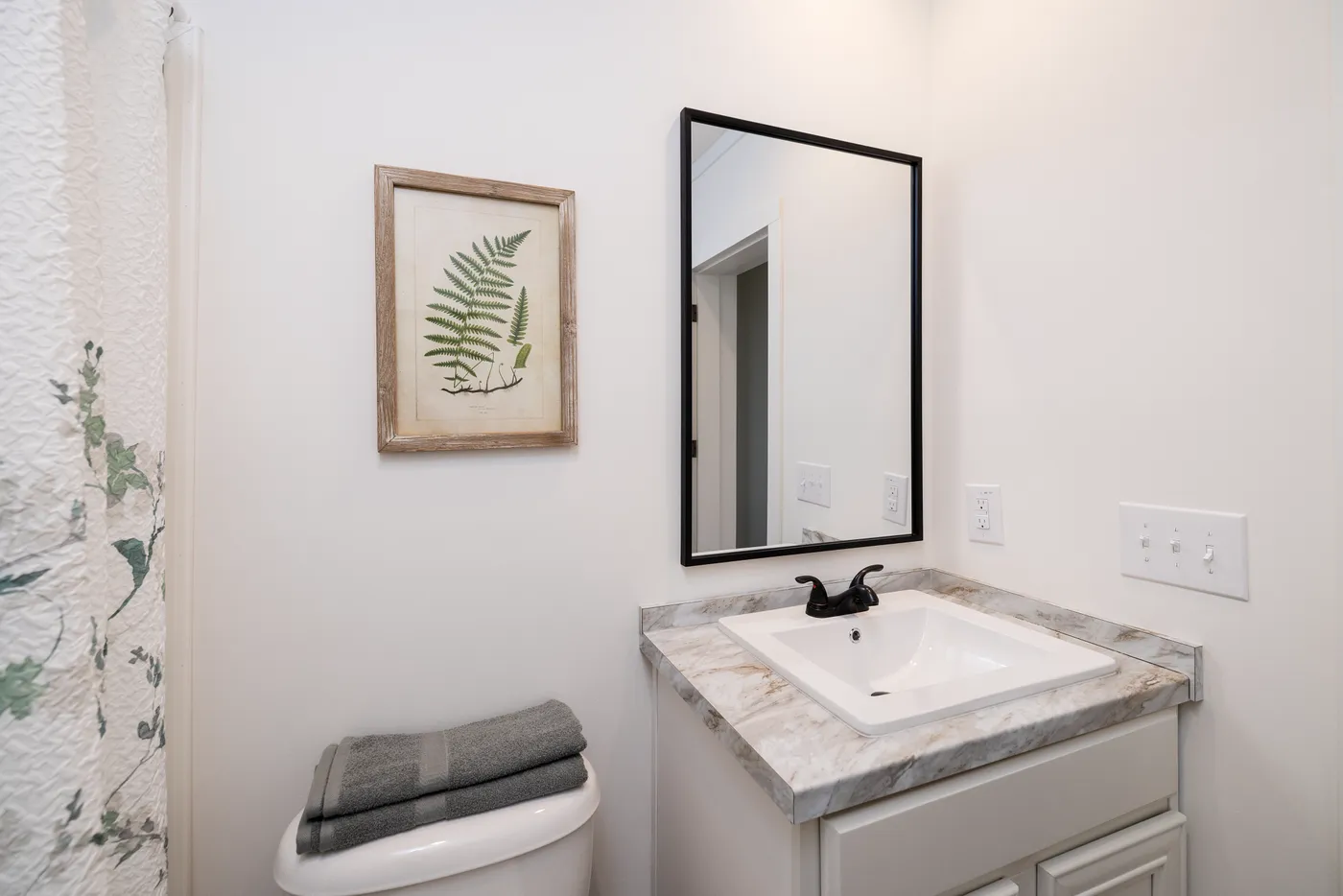 The THE ANNA FAE Guest Bathroom. This Manufactured Mobile Home features 3 bedrooms and 2 baths.