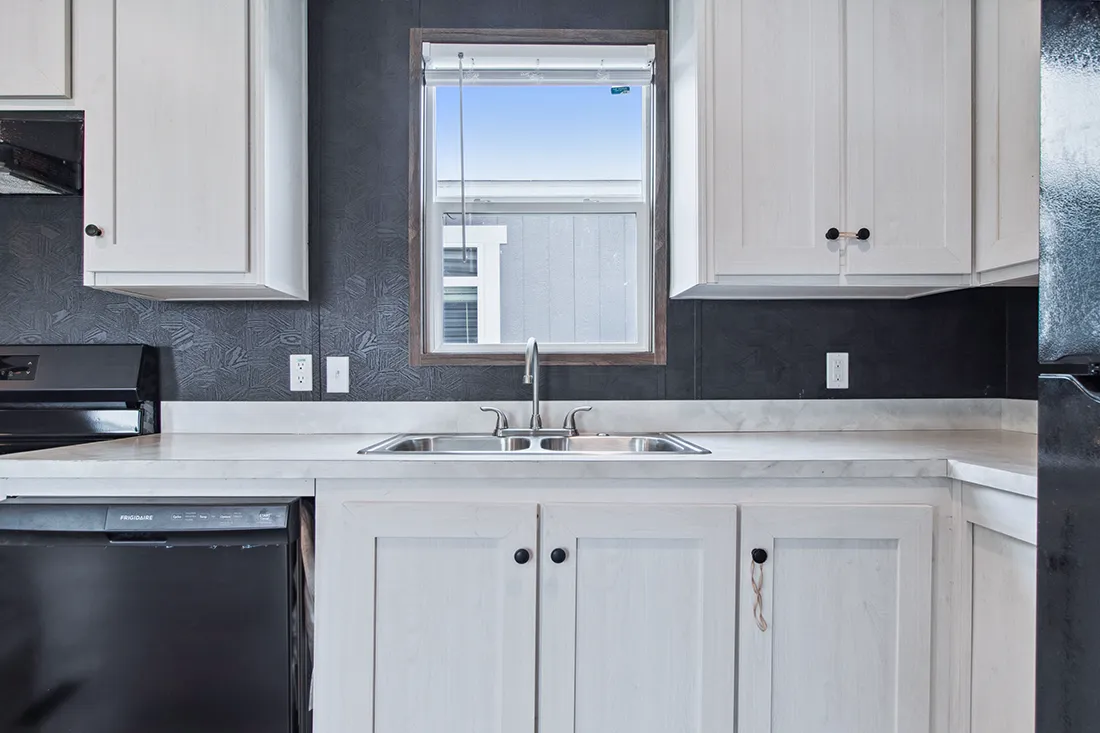 The HOMESTEAD 16562A Kitchen. This Manufactured Mobile Home features 2 bedrooms and 2 baths.