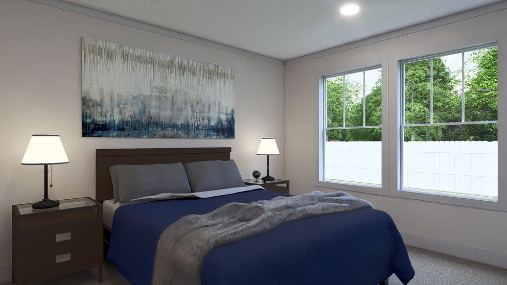 The JOHNNY B GOODE Primary Bedroom. This Manufactured Mobile Home features 3 bedrooms and 2 baths.