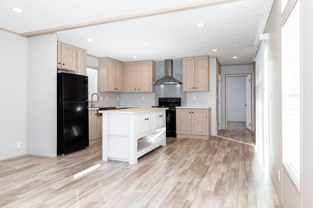 The THE ANNIVERSARY ISLANDER Kitchen. This Manufactured Mobile Home features 3 bedrooms and 2 baths.