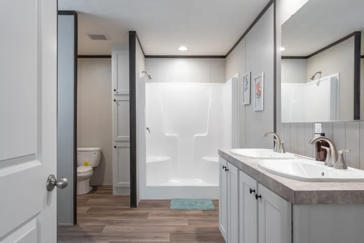The EMPOWER Primary Bathroom. This Manufactured Mobile Home features 4 bedrooms and 2 baths.
