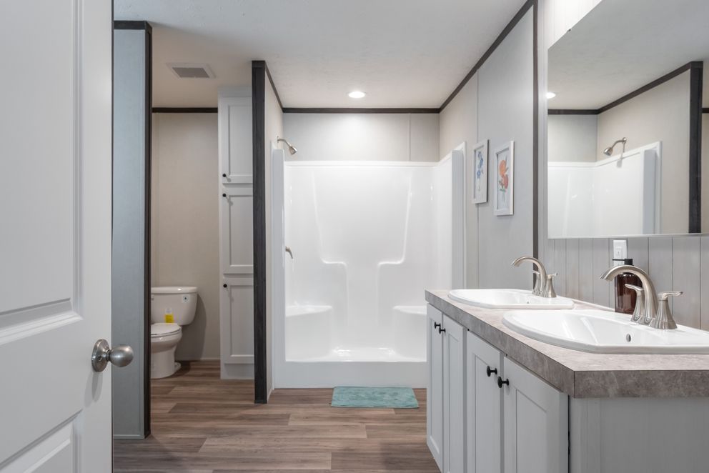 The EMPOWER Primary Bathroom. This Manufactured Mobile Home features 4 bedrooms and 2 baths.