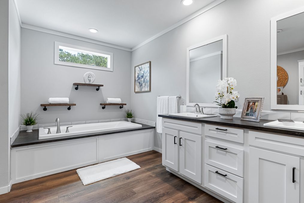 The THE MONTERREY Guest Bathroom. This Manufactured Mobile Home features 4 bedrooms and 3 baths.